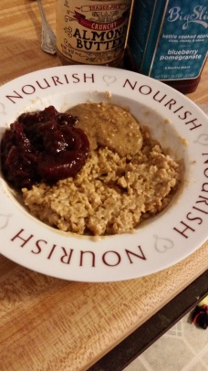 Gluten-free rolled oats with chunky almond butter, hempseeds, and pomegranate stewed apples
