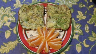 Avocado on Ezekiel bread with a clementine